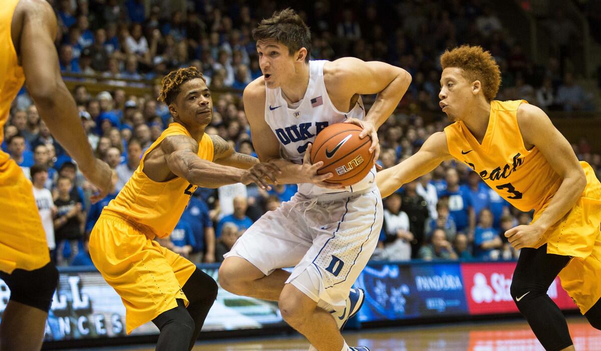 Duke’s Grayson Allen, center, handles the ball as Long Beach State’s Nick Faust, left, and Long Beach State’s Noah Blackwell defend during the second half on Wednesday.