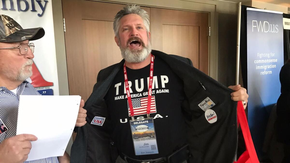 Jim Shoemaker, a Republican delegate from San Joaquin county, displays his support for President Trump at the California Republican Party convention in Sacramento on Saturday