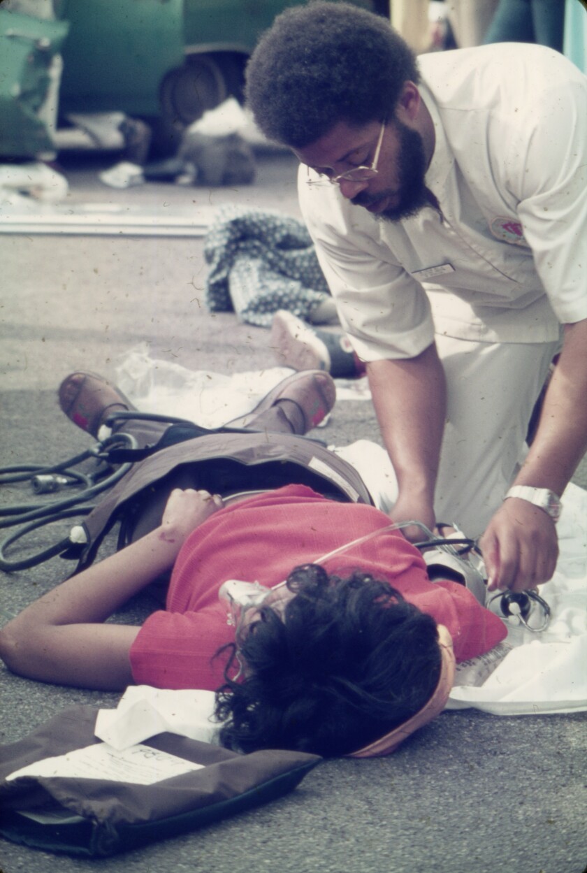 A Freedom House Ambulance EMT caring for a patient, circa 1971-75.
