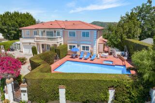 The 1980s home spans four stories with five bedrooms, 5.5 bathrooms and balconies on each side.