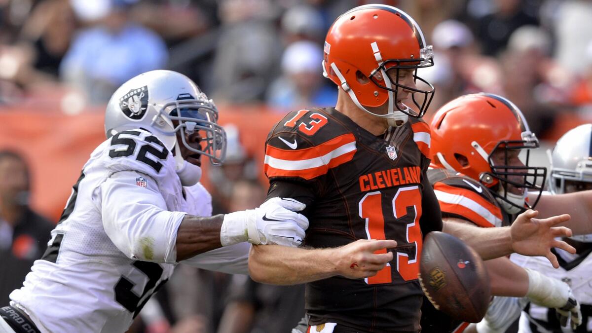 Raiders defensive end Khalil Mack (52) forces Browns quarterback Josh McCown to fumble in the second half Sunday.