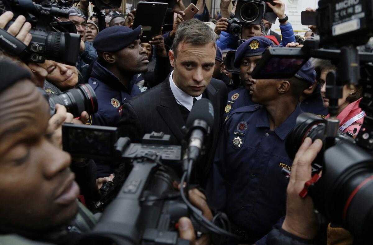 Oscar Pistorius surrounded by cameras.
