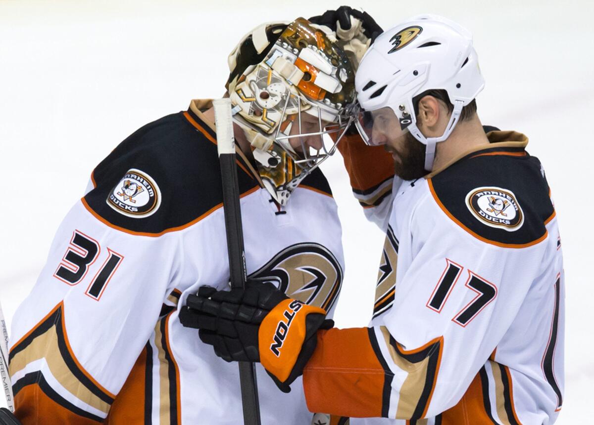 Center Ryan Kesler, right, embraces goalie Frederik Anderson after his third career shutout, a 4-0 Ducks win over the Canucks in Vancouver.