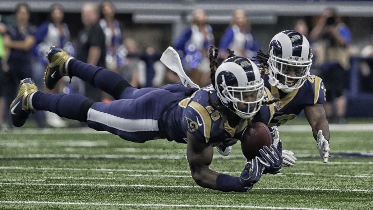 Rams linebacker Mark Barron intercepts a pass in front of teammate Nickell Robey-Coleman.