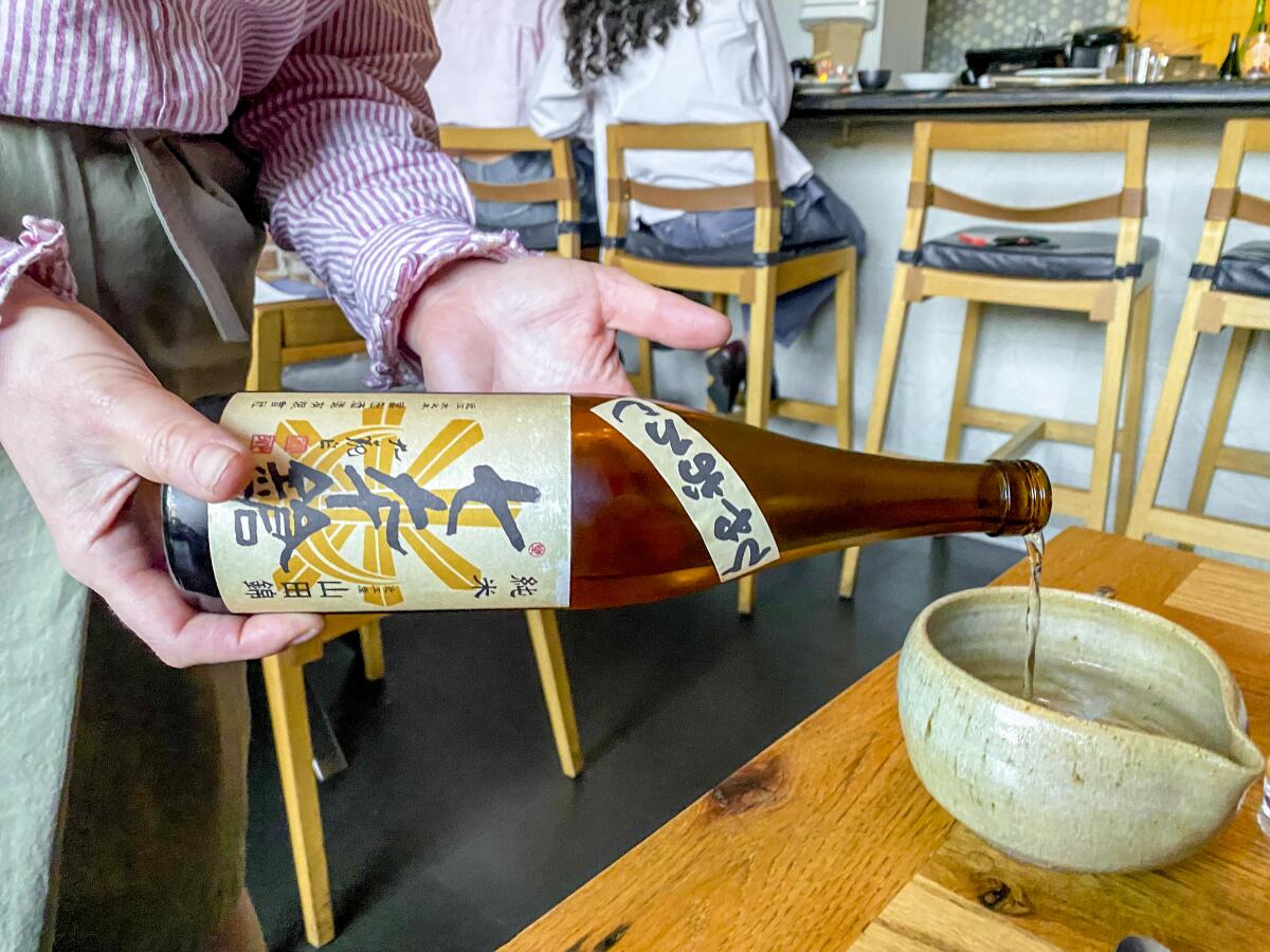 Courtney Kaplan pours sake at Tsubaki in Echo Park.