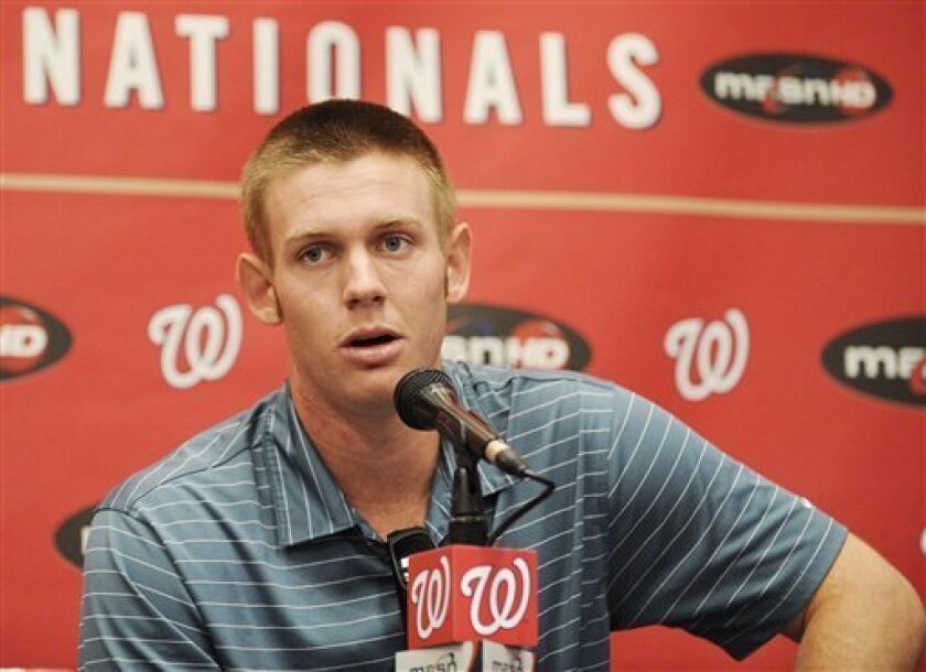 Washington Nationals pitcher Stephen Strasburg talks to the media about his injury during a press conference before a baseball game against the St. Louis Cardinals, Friday, Aug. 27, 2010, in Washington. Strasburg has a torn elbow ligament and will likely have Tommy John surgery, bringing the pitcher's promising rookie season to an abrupt end. (AP Photo/Nick Wass)