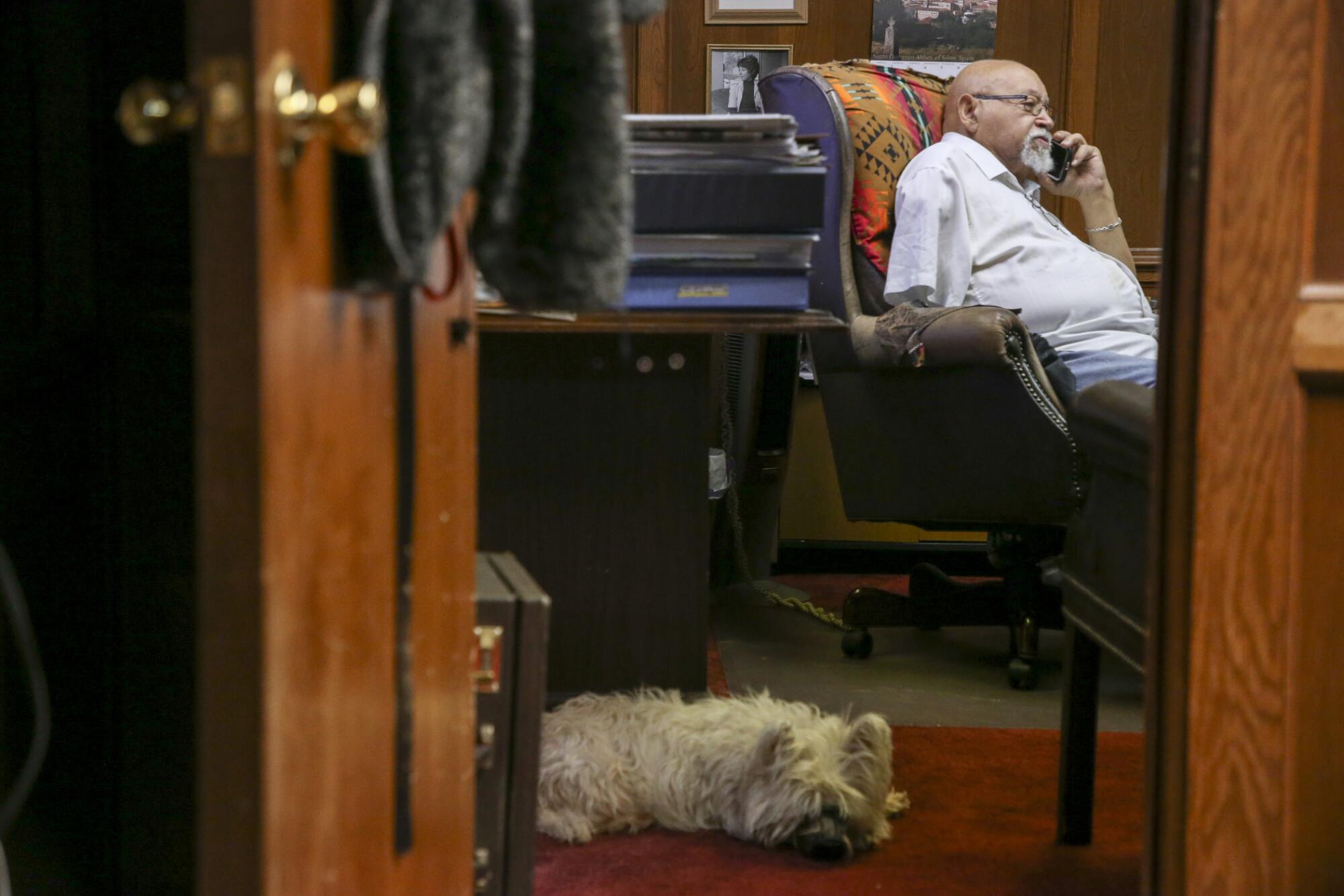Jim Goodwin and Annie the Westie inside the Oklahoma Eagle offices. 