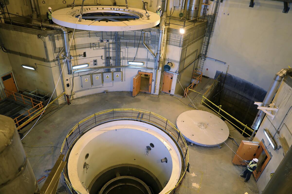 In this photo released by the Atomic Energy Organization of Iran, technicians work on the Arak heavy water reactor's secondary circuit, near Arak, 150 miles (250 kilometers) southwest of the capital Tehran, Iran, Dec. 23, 2019. France, Germany and Britain have urged Iran to agree to a proposed relaunch of the agreement limiting its nuclear program, saying final texts of a deal have been readied but Iran “has chosen not to seize this critical diplomatic opportunity.” The three European governments said Saturday, Sept. 10, 2022 Iran continues to escalate its nuclear program beyond any civilian justification. (Atomic Energy Organization of Iran via AP)
