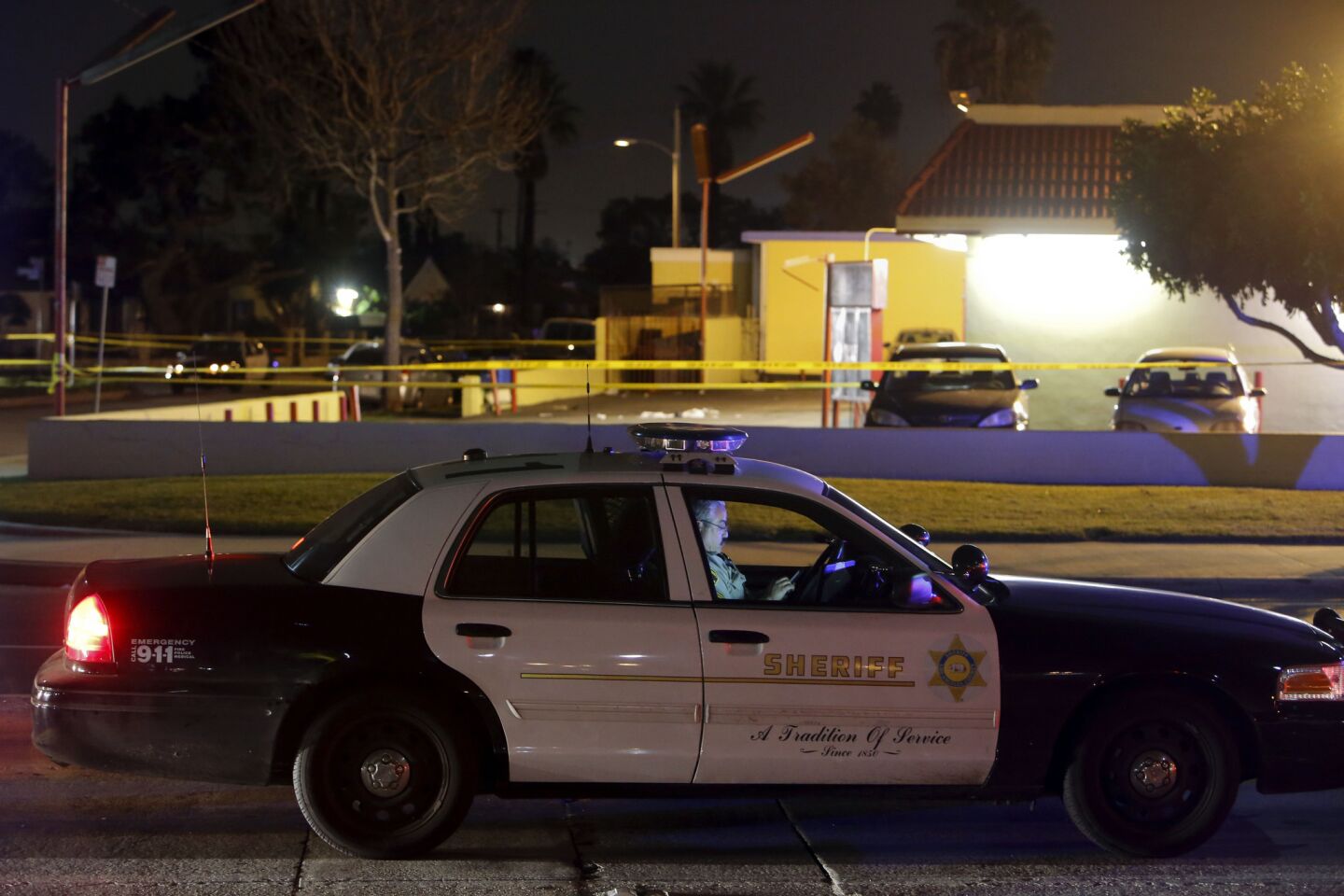 Los Angeles County sheriff's officials at the site of a hit-and-run in Compton involving music mogul Suge Knight.