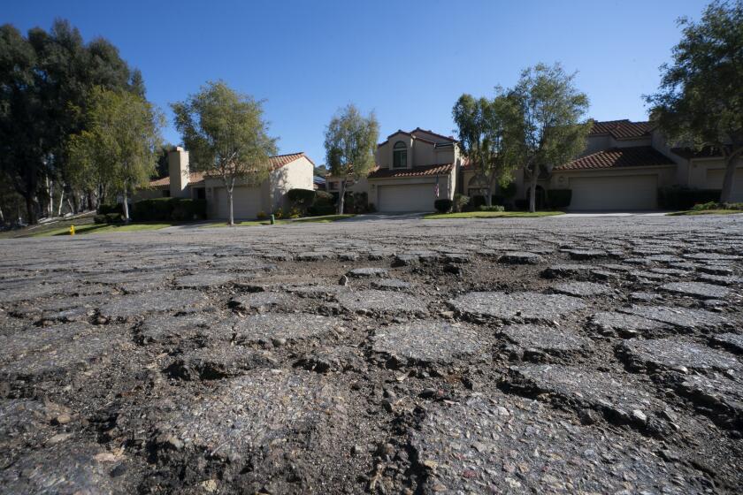 San Diego, CA - January 16: In the residential community on Mayita Way in Tierrasanta, evidence of crumbling asphalt and cracks appears throughout the neighborhood streets. (Nelvin C. Cepeda / The San Diego Union-Tribune)