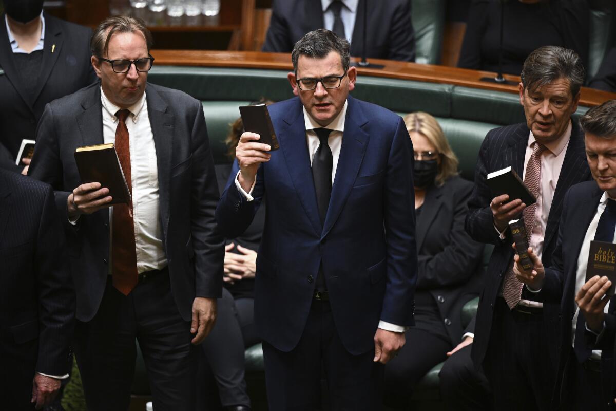 Victorian state Premier Daniel Andrews, center, joins in with fellow members pledging their allegiance to King Charles III at the Victorian State Parliament in Melbourne, Australia, Tuesday, Sept. 13, 2022. (James Ross/AAP Image via AP)