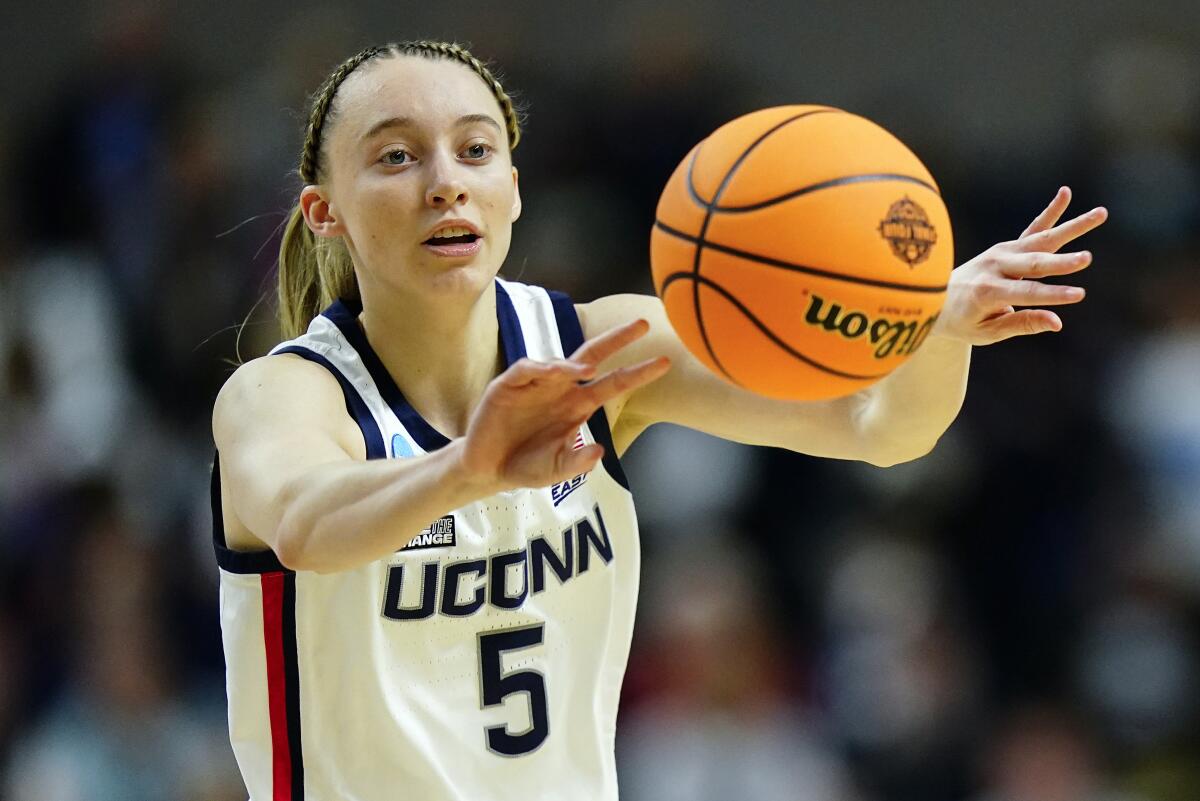 FILE - Connecticut guard Paige Bueckers (5) passes the ball during the first quarter of an NCAA college basketball game against Indiana in the Sweet Sixteen of the NCAA women's tournament on March 26, 2022, in Bridgeport, Conn. Bueckers tore the ACL in her left knee and will miss the entire 2022-23 season, the school announced Wednesday, Aug. 3, 2022. (AP Photo/Frank Franklin II, File)
