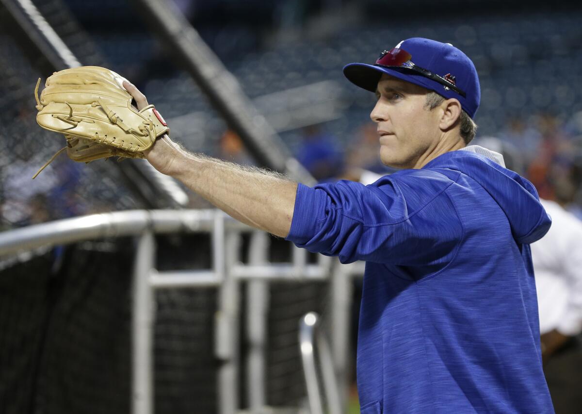 Dodgers infielder Chase Utley warms up before the start of a playoff game against the New York Mets.