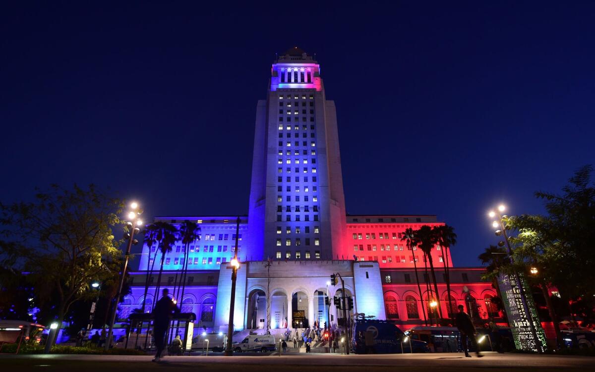 Los Angeles City Hall is lit up in the colours of the French flag during a vigil for the victims of last Friday's attacks in Paris.