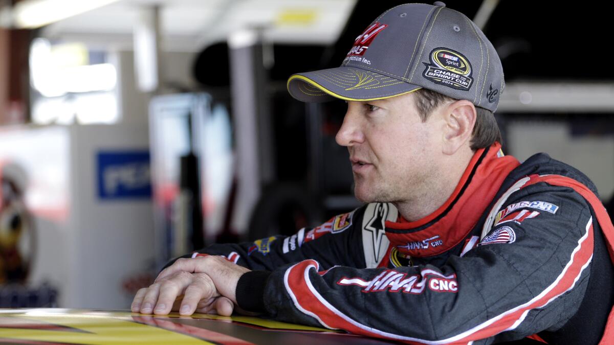 Kurt Busch speaks to his crew during a practice session at Chicagoland Speedway on Sept. 13, 2014.