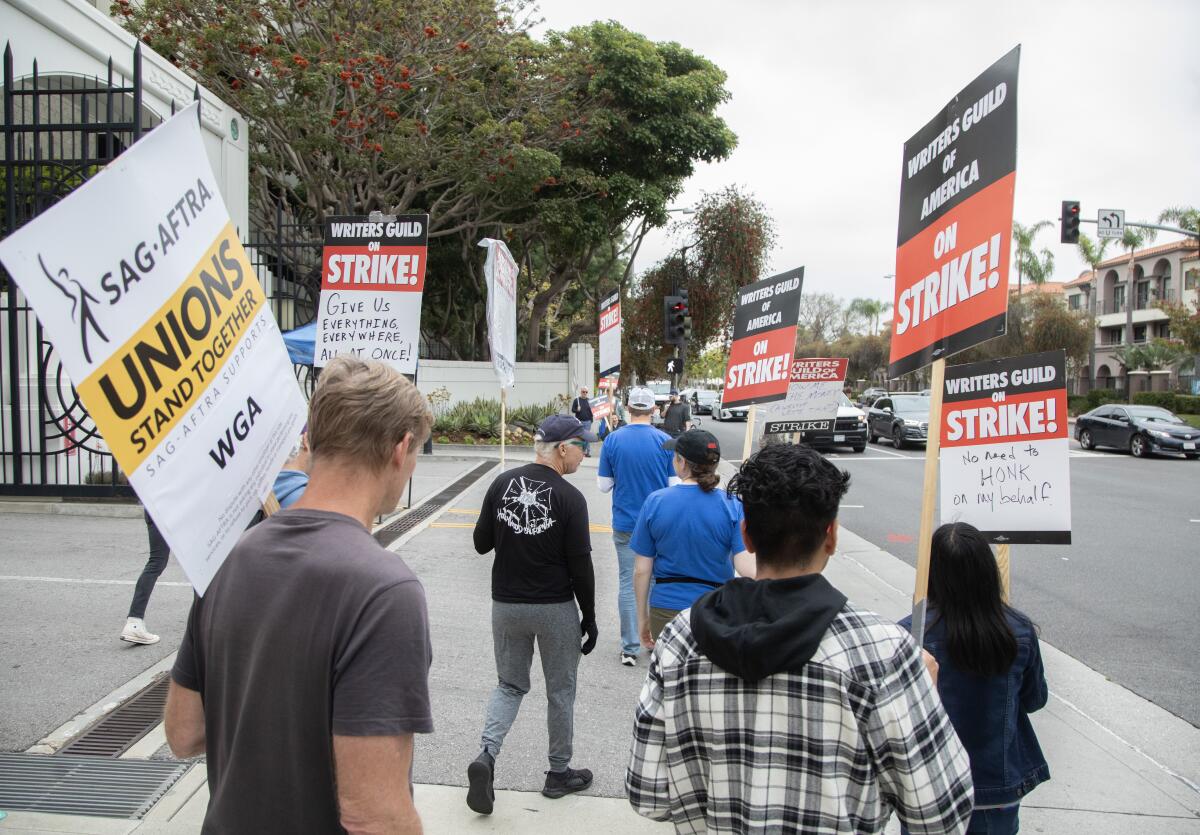 People carrying signs picket outside Sony Studios 