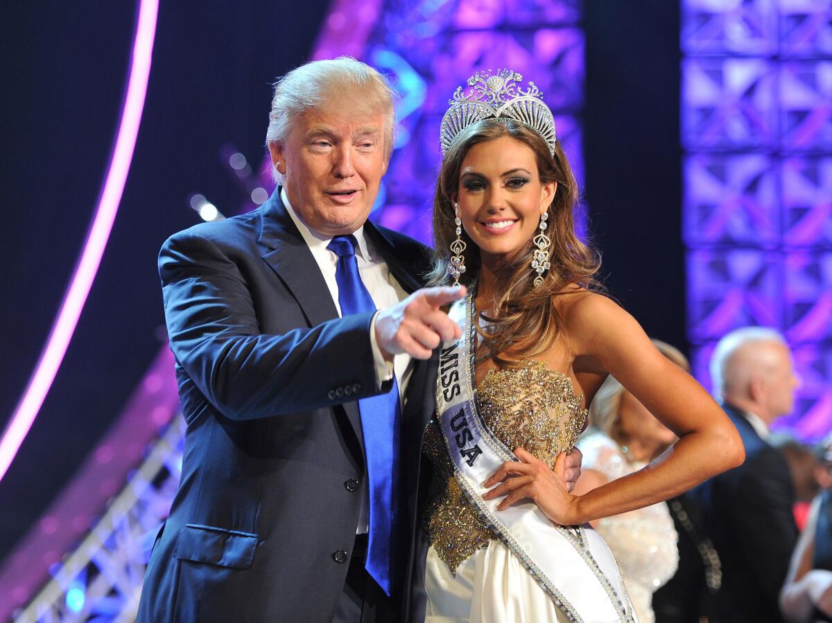 Donald Trump poses in 2013 with Miss USA winner Erin Brady. The Reelz channel says it will air the 2015 pageant after it was dropped by NBC.
