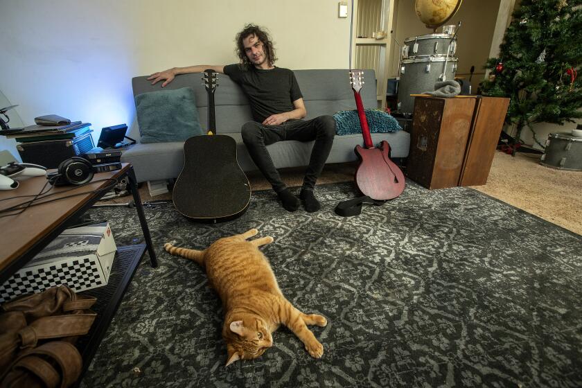 Rob Leonard, 34, is photographed with his cat Jonesy, inside his apartment in Santa Monica.