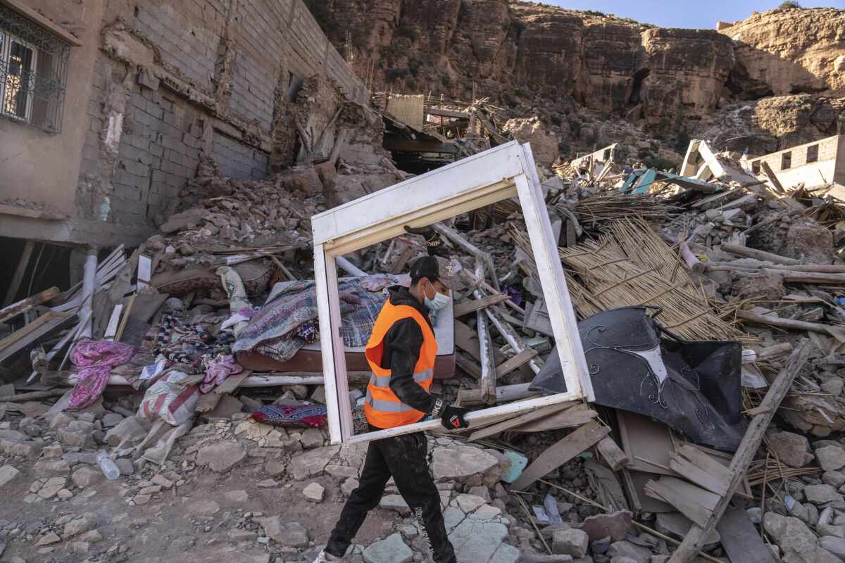 Volunteer salvaging furniture from earthquake-damaged homes