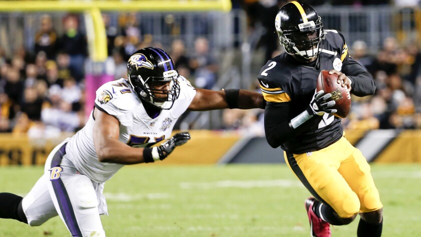 Steelers quarterback Michael Vick (2) scrambles from Ravens linebacker Daryl Smith during the second quarter Thursday night in Pittsburgh.