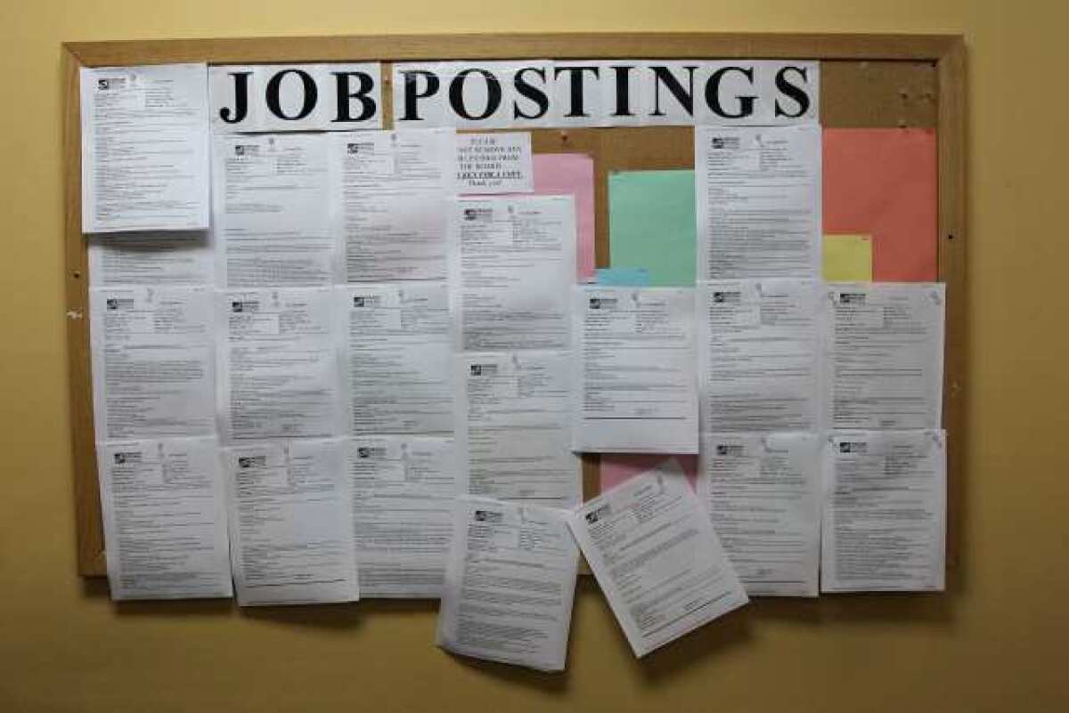 A jobs posting board hangs on a wall at Central City Concern in Portland, Ore. Job openings were up slightly in May.
