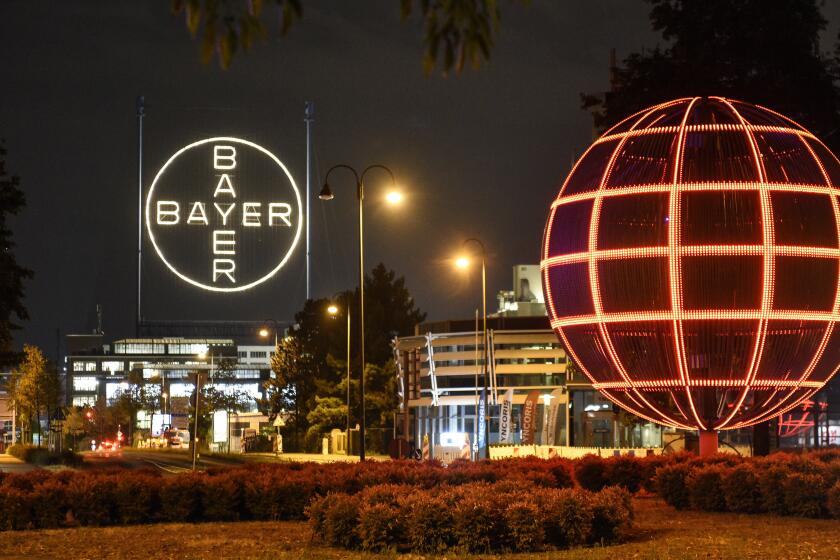 FILE - The Bayer logo is pictured at the main chemical plant of German Bayer AG on Thursday, Aug. 9, 2019 in Leverkusen, Germany. A low-rise city of 167,000 that grew up around the factories of the pharmaceuticals giant Bayer, Leverkusen has little to draw tourists besides its internationally famed soccer club. The team finished an entire German Bundesliga season unbeaten Saturday and is now targeting trophies in the Europa League and German Cup. (AP Photo/Martin Meissner, File)