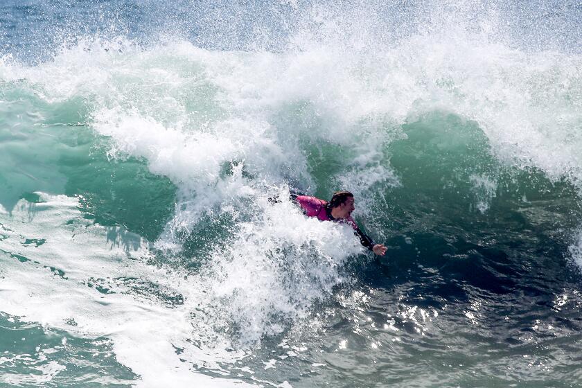 NEWPORT BEACH, CALIF. - JULY 20, 2022. A body surfer slices through a big wave at The Wedge in Newport Beach on Wednesday, July 20, 2022.. High surf advisories are in effect for beaches from San Diego to Ventura as big waves from a South Pacific storm pound the shoreline. (Luis Sinco / Los Angeles Times)