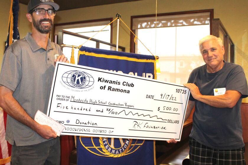 Montecito construction teacher Nick Jordan, left, accepts a $500 check from Kiwanis Club of Ramona President Patrick Bell.