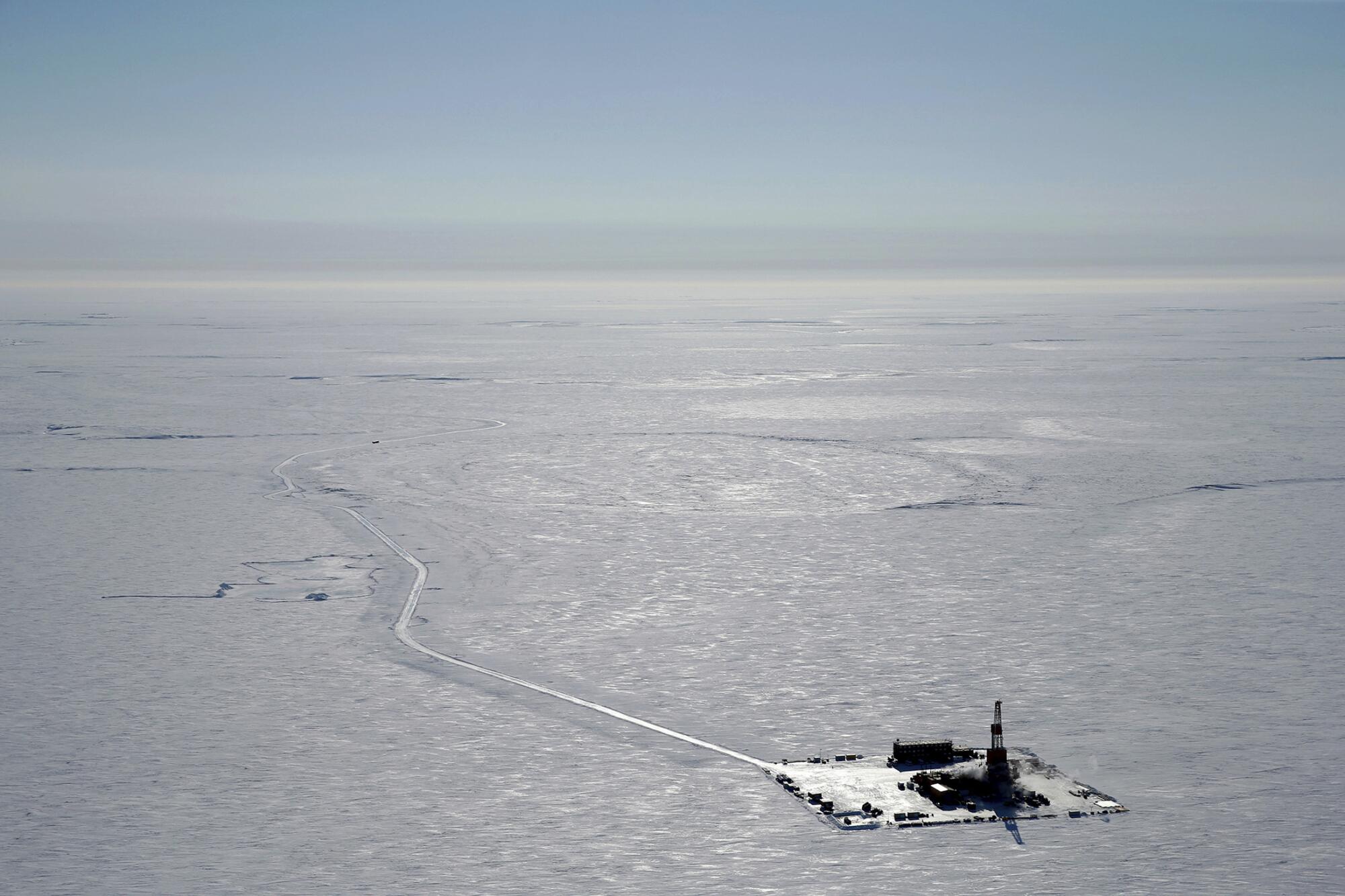 A drilling rig in an arctic icescape.