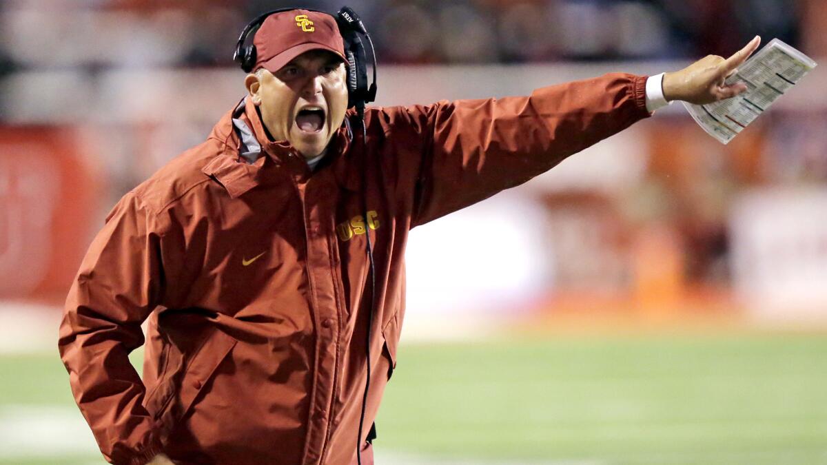 Coach Clay Helton shouts instructions in the second half of USC's game at Utah.