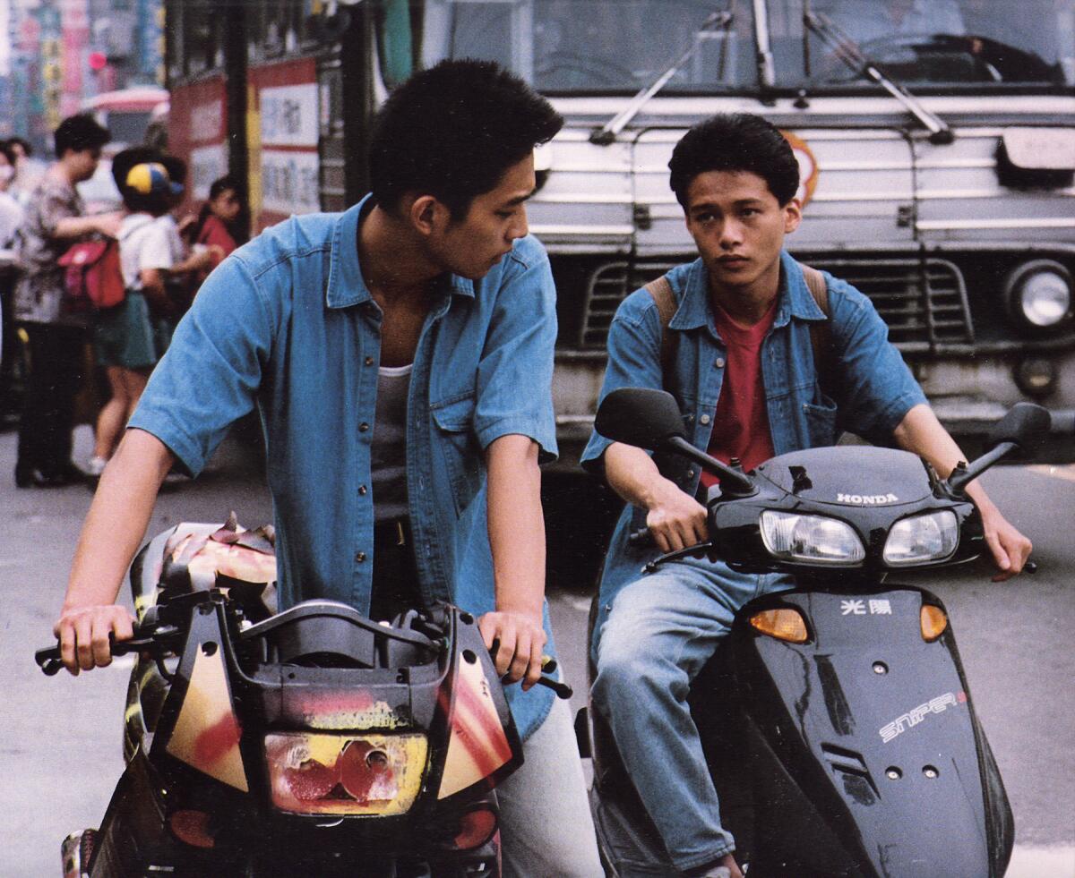 Two men on bikes having a conversation