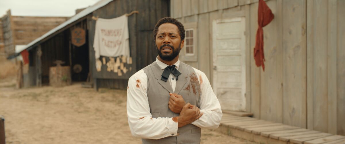 A well-dressed man with blood on his shirt in the movie “Ghosts of the Ozarks.”
