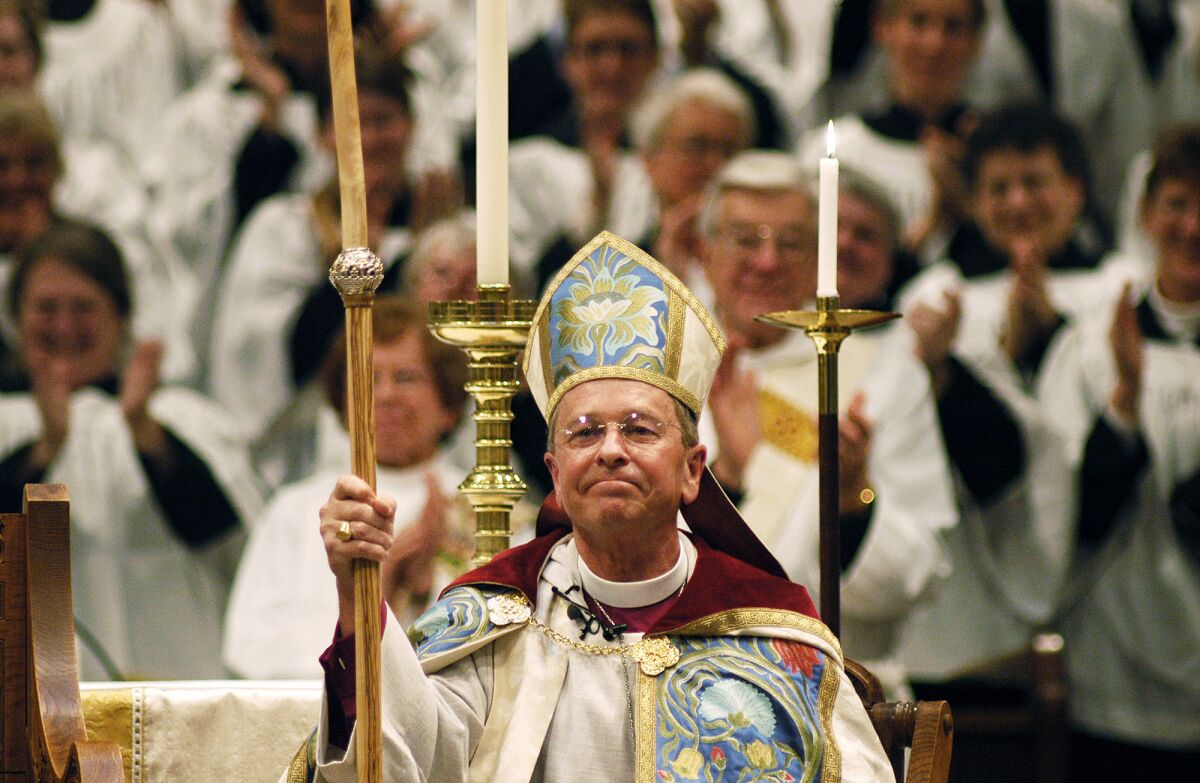 Gene Robinson is applauded after his investiture as the Episcopal Church's bishop of New Hampshire in 2004. 