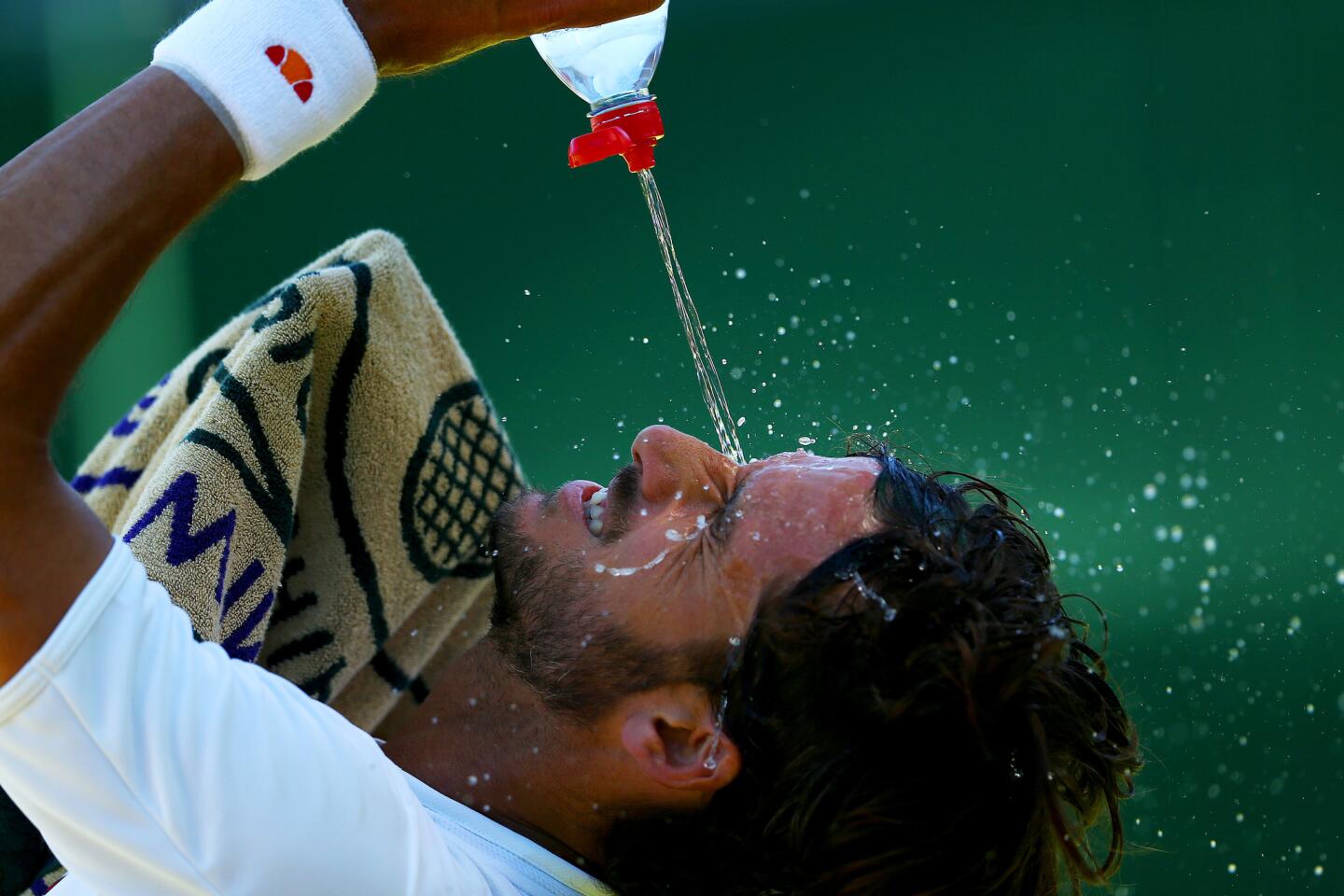 LONDON, ENGLAND - JUNE 30: Feliciano Lopez of Spain cools down in his Gentlemens Singles first round match against Steve Darcis of Belgium during day two of the Wimbledon Lawn Tennis Championships at the All England Lawn Tennis and Croquet Club on June 30, 2015 in London, England. (Photo by Clive Brunskill/Getty Images) ** OUTS - ELSENT, FPG - OUTS * NM, PH, VA if sourced by CT, LA or MoD **