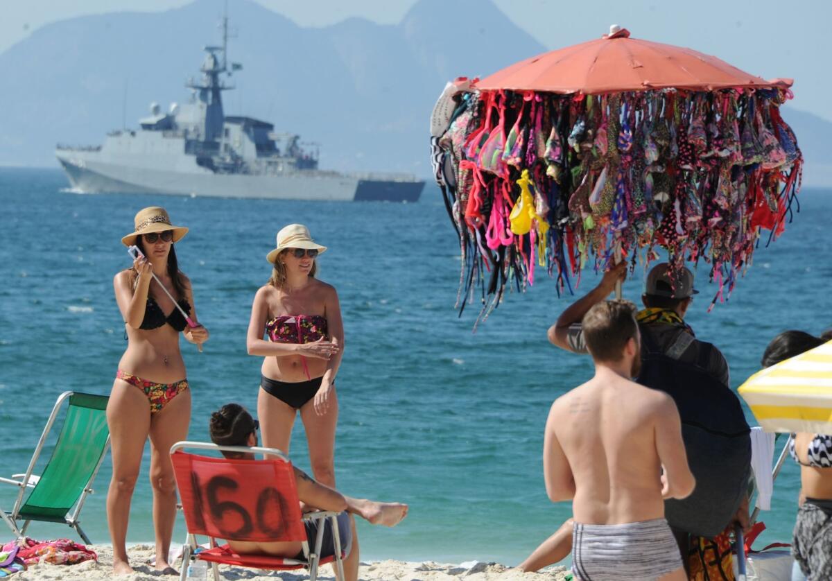 People enjoy the day at Copacabana beach as a ship patrols the coast enhancing security ahead of the Rio 2016 Olympic Games, in Rio de Janeiro, Brazil, on July 24, 2016. / AFP PHOTO / TASSO MARCELOTASSO MARCELO/AFP/Getty Images ** OUTS - ELSENT, FPG, CM - OUTS * NM, PH, VA if sourced by CT, LA or MoD **