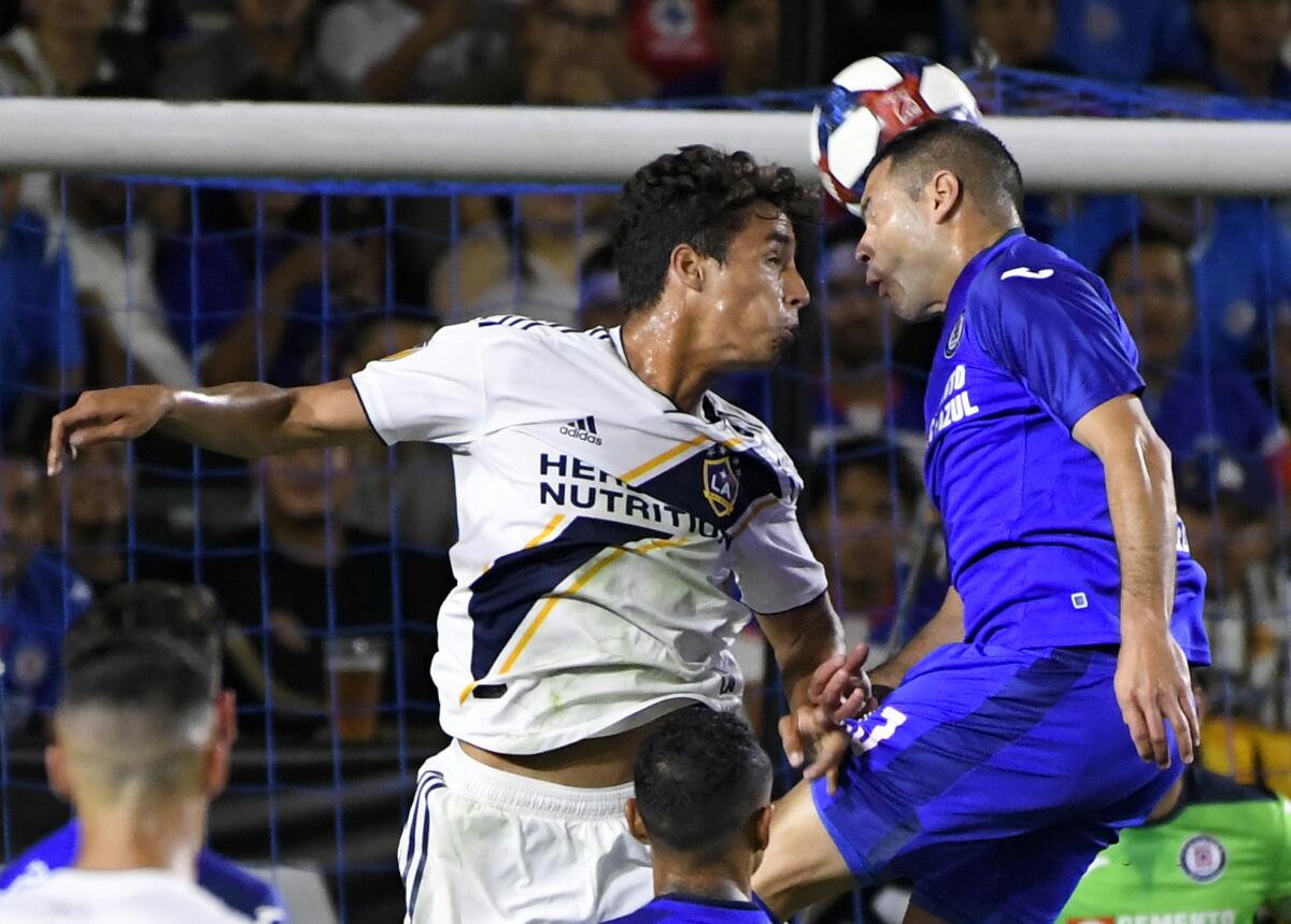 The Galaxy's Ethan Zubak, left, and Cruz Azul's Pablo Aguilar battle for the ball during Tuesday's match.