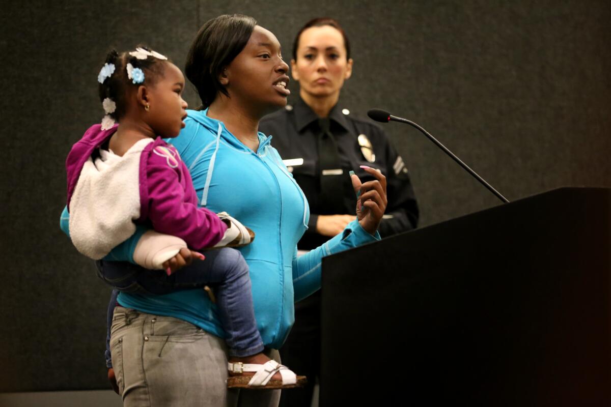 Brandy Brown, holding daughter Desire Cannady, speaks at the Los Angeles Board of Police Commissioners meeting May 12.