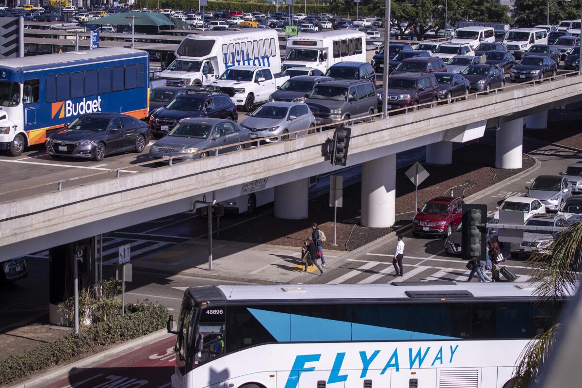 Cars and buses navigate traffic at Los Angeles International Airport amid the Thanksgiving holiday rush in Los Angeles