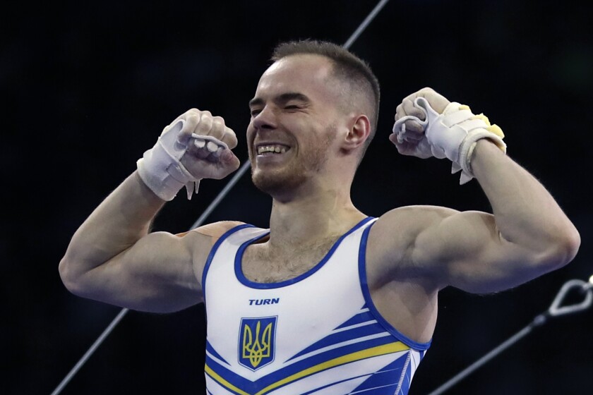 FILE - In this file photo dated Friday, Oct. 11, 2019, Oleg Verniaiev of Ukraine celebrates after his performance on the horizontal bar in the men's all-around final at the Gymnastics World Championships in Stuttgart, Germany. Olympic champion gymnast Oleg Verniaiev will miss the Tokyo Games after testing positive for a prohibited drug and banned for four-years Tuesday July 13, 2021, by the Gymnastics Ethics Foundation. Verniaiev denies wrongdoing and says he will appeal the ruling. (AP Photo/Matthias Schrader, FILE)