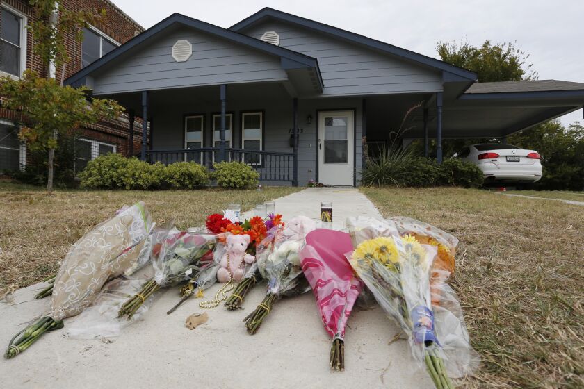 FILE - In this Monday, Oct. 14, 2019, photo, flowers lie on the sidewalk in front of the house in Fort Worth, Texas, where a white Fort Worth police officer Aaron Dean shot and killed Atatiana Jefferson, a black woman, through a back window of her home. Jury selection began Monday, Nov. 28, 2022, in the the murder trial of the former Fort Worth police officer Dean, who fatally shot Jefferson in 2019, while responding to a call about an open front door. (AP Photo/David Kent, File)