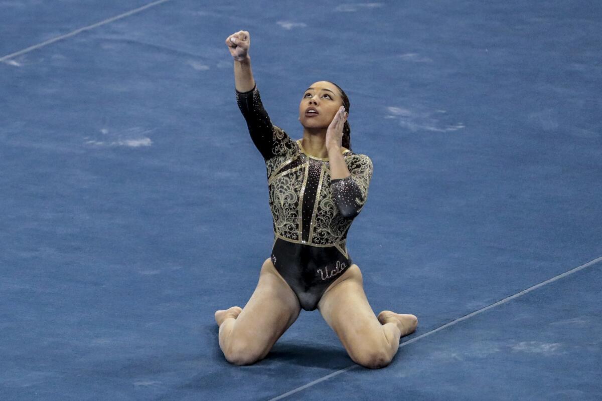 UCLA gymnast Margzetta Frazier flashes the "Black power" sign.