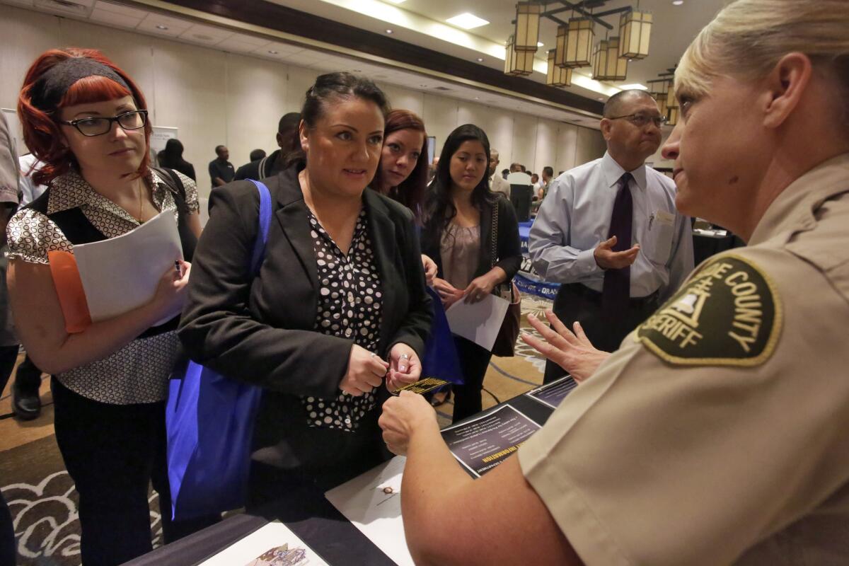 Visitors to a career fair in the Inland Empire learn about potential jobs. There could be big changes in the workplace this year.