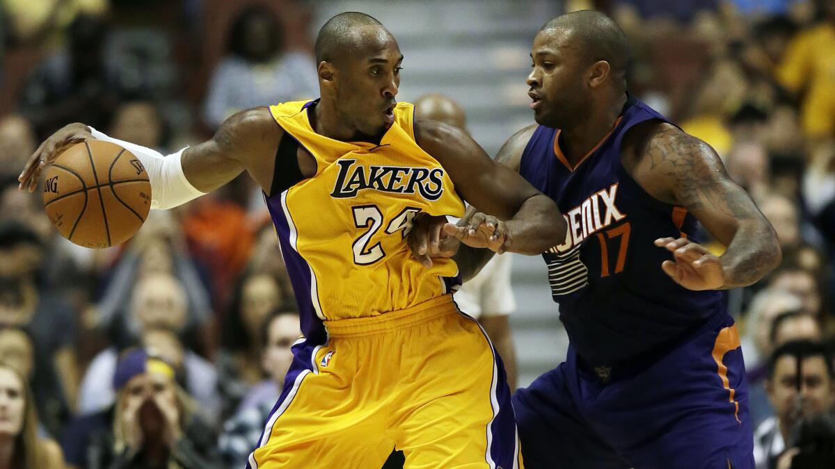 Lakers star Kobe Bryant, left, drives on Phoenix Suns forward P.J. Tucker during the fourth quarter of the Lakers' 114-108 exhibition loss at Honda Center on Tuesday.