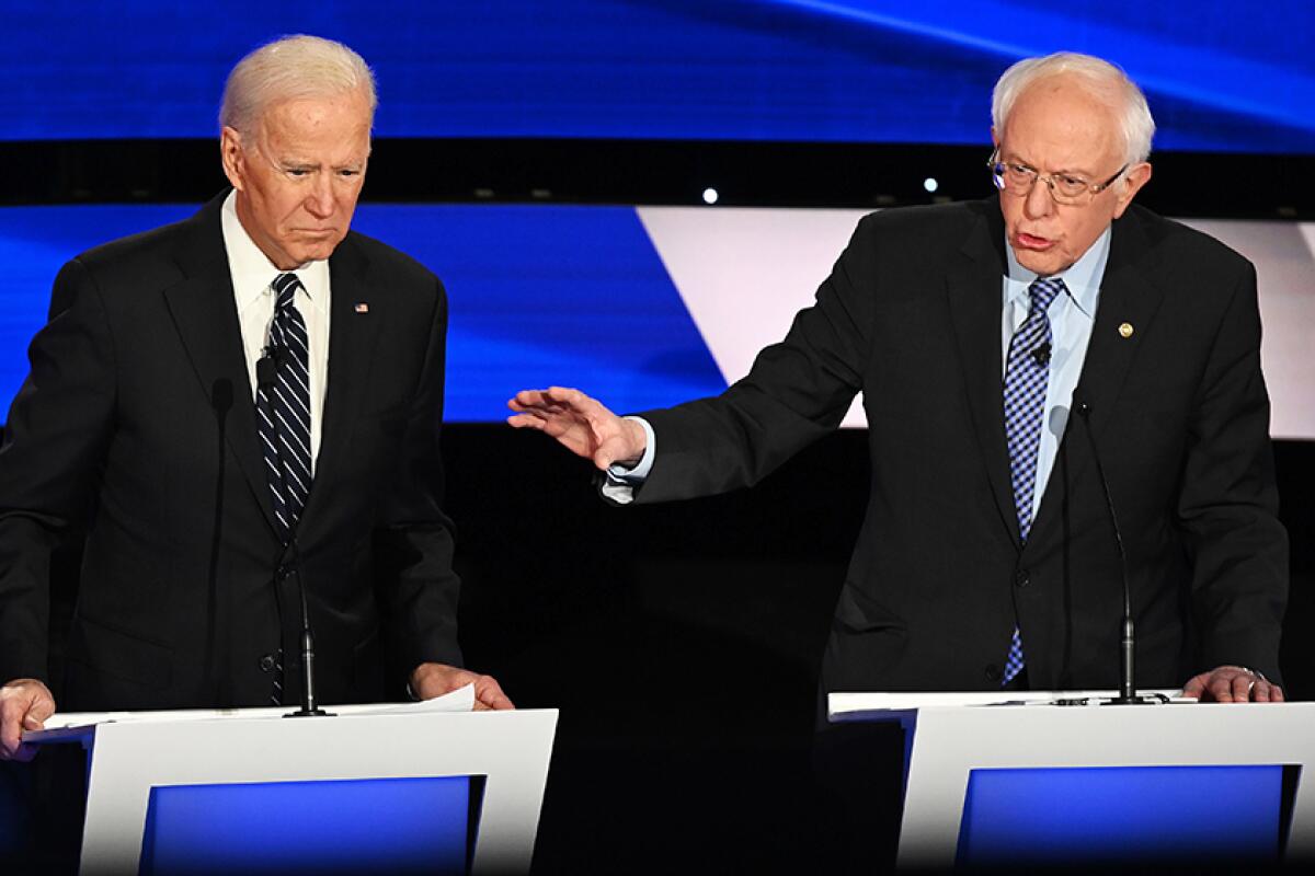 Presidential hopefuls  Joe Biden, left, and Bernie Sanders take part in a Democratic debate in Des Moines, Iowa, on Jan. 14. 