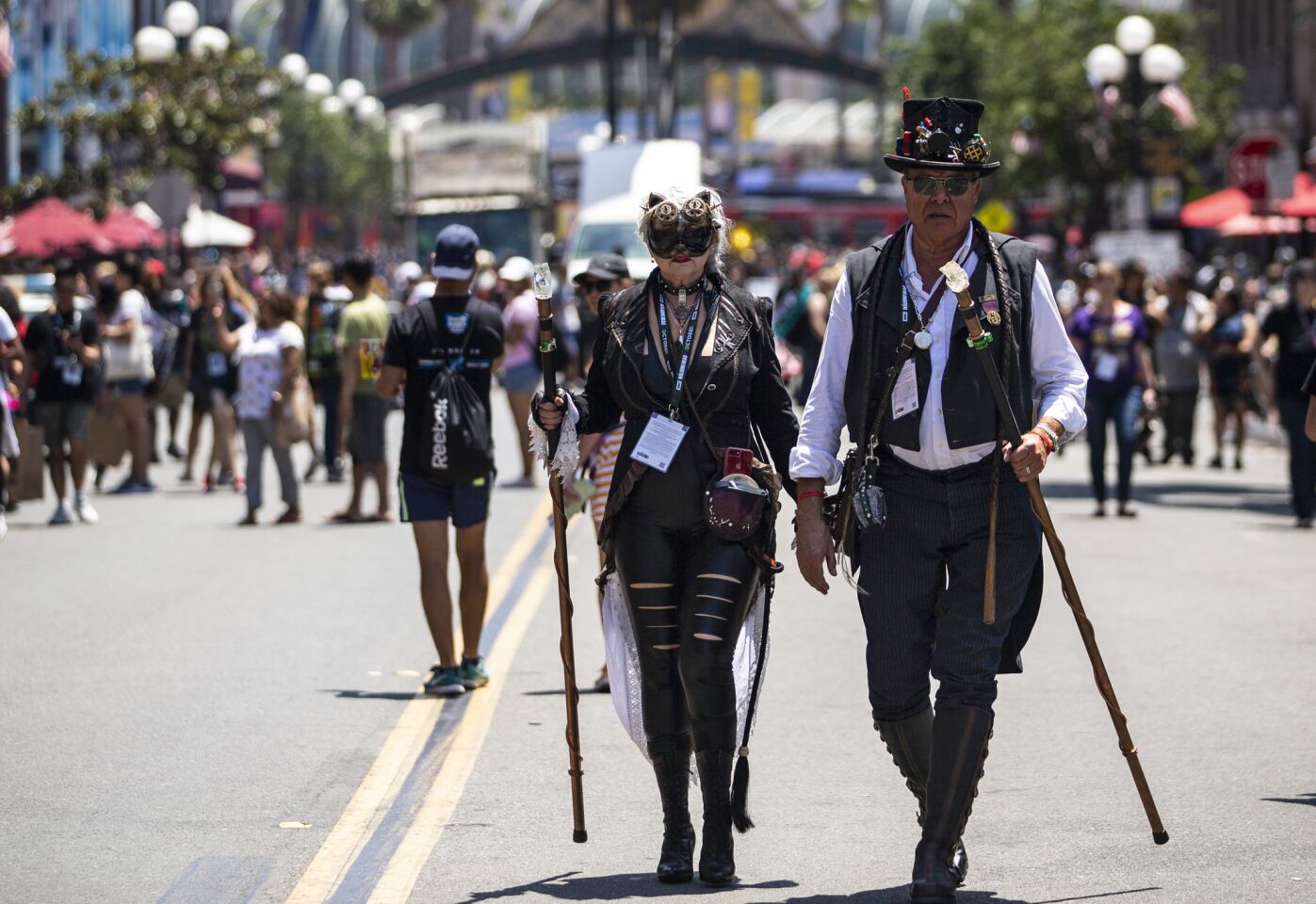 Sheila Marler cosplaying as steampunk Catwoman and David Marler cosplaying as Captain Time walk down Fifth Avenue in San Diego's Gaslamp Quarter.