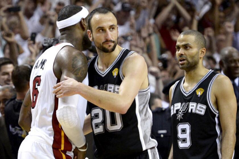 Spurs guard Manu Ginobili congratulates Heat forward LeBron James after Game 7 of the NBA Finals.