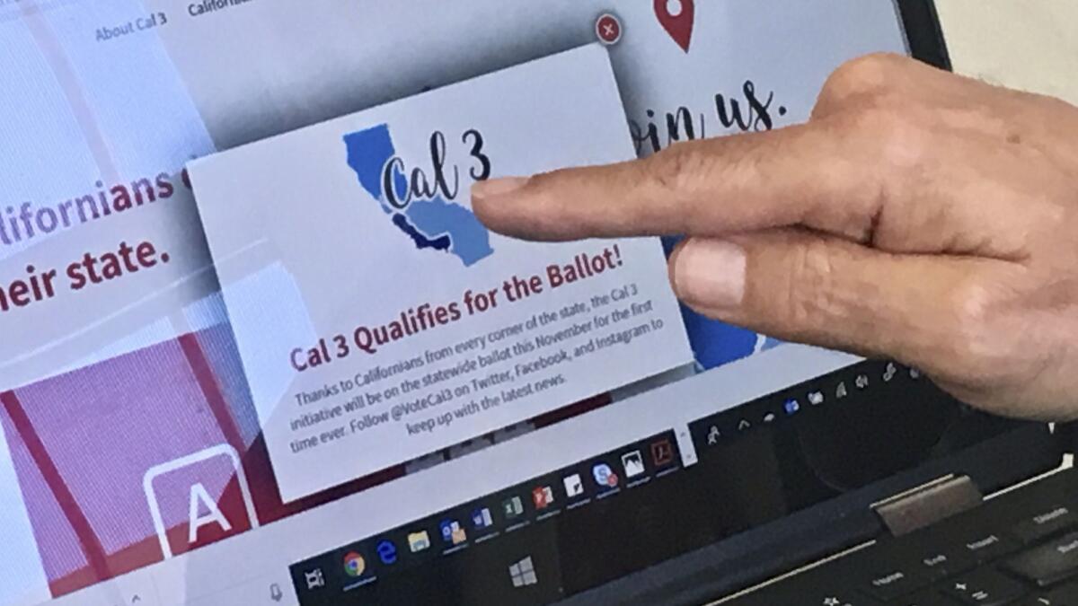 Venture capitalist Tim Draper points to a computer screen in June announcing that an initiative to split California into three states had qualified for the ballot. The state Supreme Court on Wednesday removed the measure from the ballot amid questions about its validity.