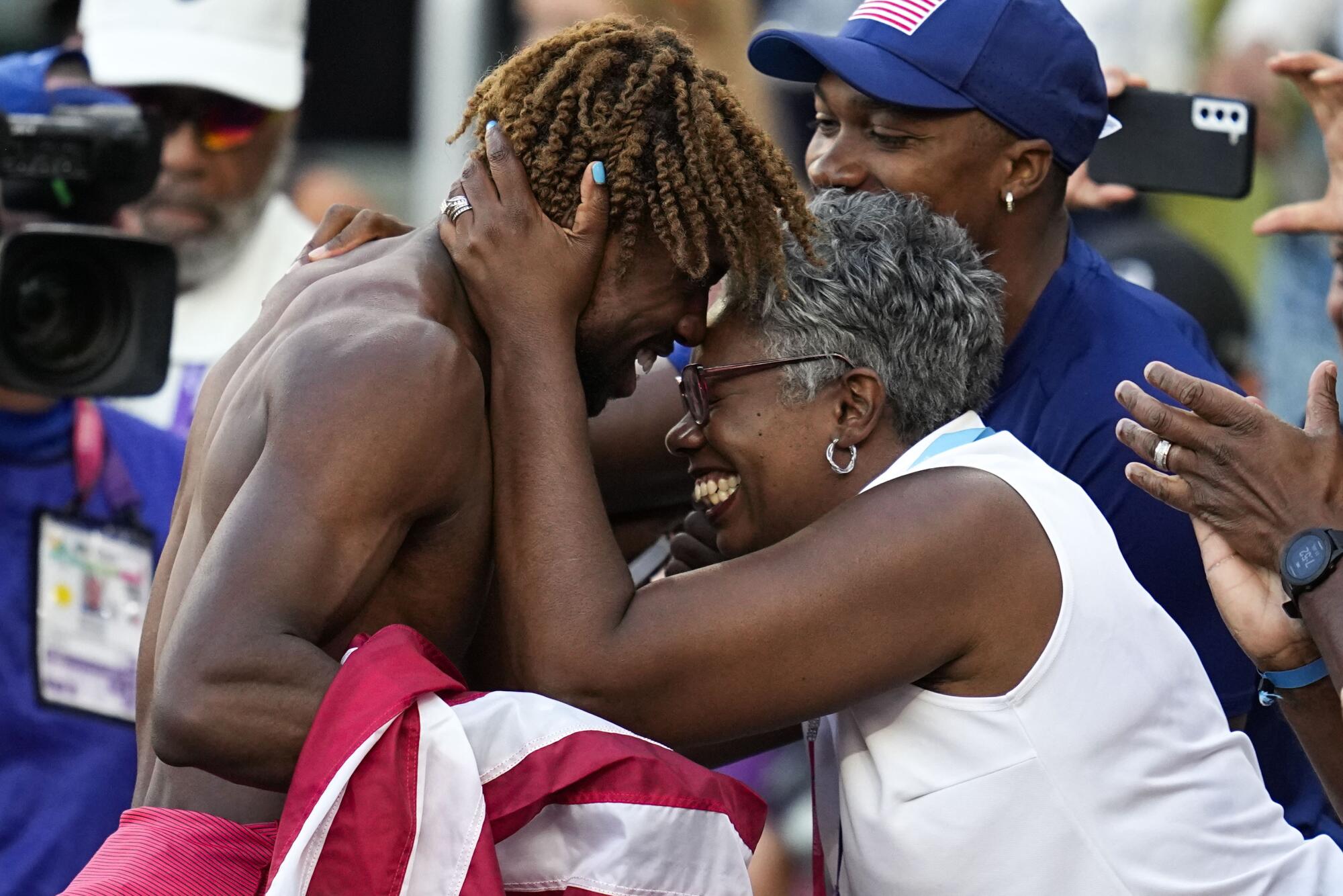 American sprinter Noah Lyles greets family after winning the 200-meter race at the world championships.