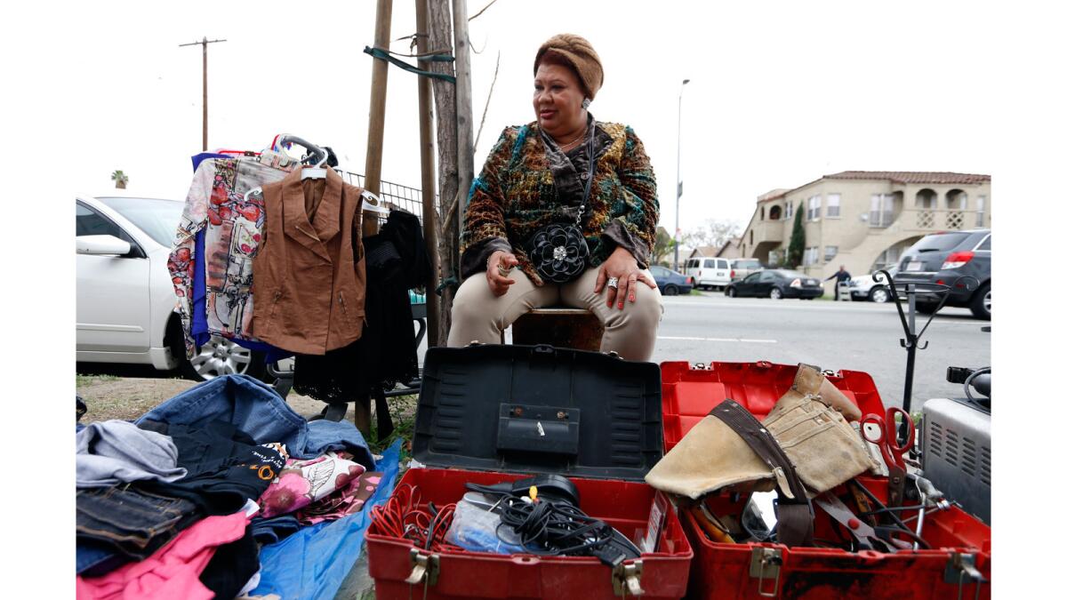 Julia Martinez, 52, who lost her job two months ago, sells clothes and other items on Figueroa Street in South Los Angeles.