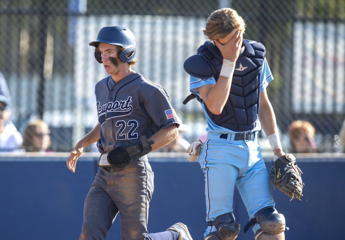Newport Harbor's Joey Wright scores on a double by Trent Liolios during a Wave League game against rival CdM on April 14.